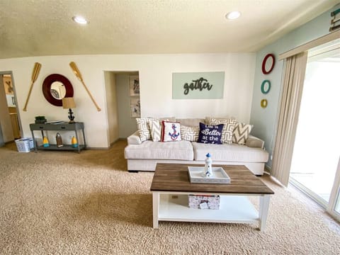 Inviting living space with plush sofa and cheerful, beach-inspired accents