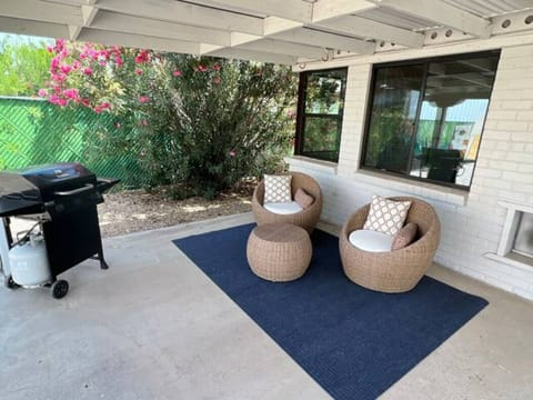 Outdoor patio features seating for 6, a gas grill and fenced yard with dog door.