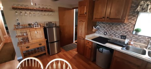 Mini bar area with beverage fridge and freezer. 