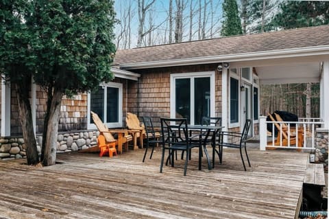 Outside dining table with Gas Grill and plenty of chairs to enjoy the views of Torch Lake Sunsets!