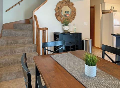 Dining area is adjacent to the kitchen. Stairs lead to second floor.