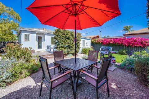 Patio table and grill in the backyard, looking back towards the house.
