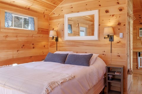The inviting queen-size bed is dressed in soft, high-quality linens