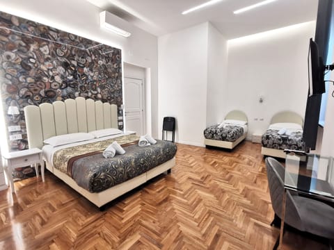 Deluxe Quadruple Room | Minibar, in-room safe, desk, laptop workspace
