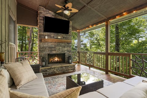 Main level back deck with wood burning fireplace and big screen smart tv