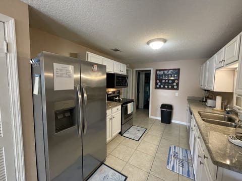 Kitchen- Full sized Fridge, Glass Top Range and Microwave.
