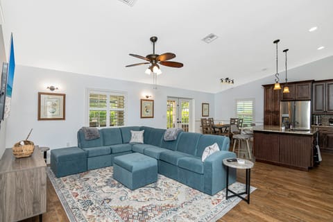Open concept kitchen, dining area and living room with vaulted ceiling