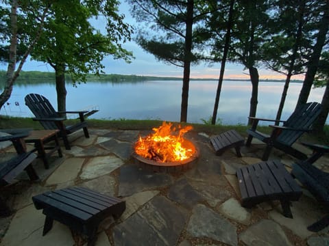 Flagstone fire pit overlooking lake with amazing Lucky View Lodge sunset views!