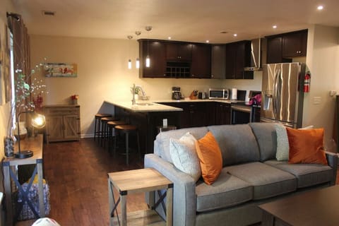 Experience the perfect fusion of comfort, functionality, and style in our short-term rental's living room with a joint kitchen and dining area. This seamless integration of spaces creates an open and inviting atmosphere.