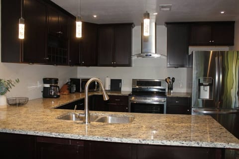 Discover culinary inspiration at our rental's captivating kitchen island. This central hub of the kitchen combines functionality and style, offering a versatile space for cooking, gathering, and creating lasting memories.