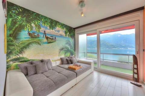 Family Apartment, Multiple Bedrooms (Melide On The Lake) | Living area | 21-inch TV with cable channels