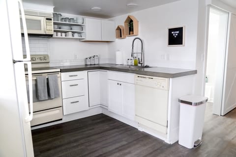 Fully stocked kitchen with spices, basic supplies.