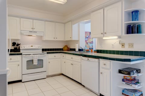 Full stocked kitchen with new appliances and utensils and lots of glassware.