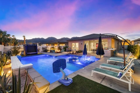 Evening glow over the sparkling pool w/ loungers & a covered patio made for sunset swims