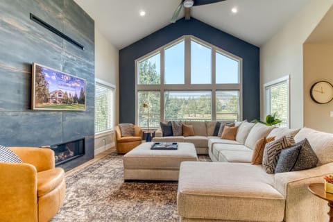 Chic comfort with a view. 🏌️‍♂️🔥🛋️
A gorgeous living room featuring a sectional sofa, golf course vistas, a linear gas fireplace, and a flat-screen TV.