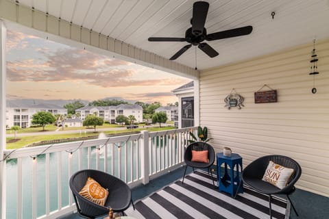 Beautiful porch overlooking koi pond. Outdoor fan, seating and, views for days