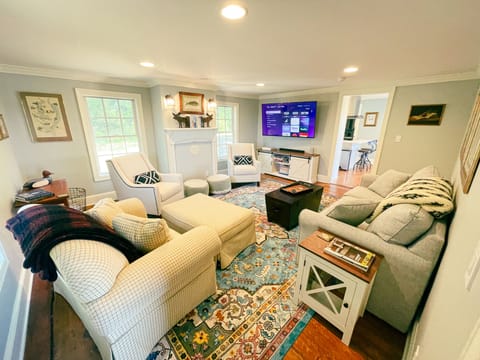 Living room seats the entire family alongside a 65" smart TV
