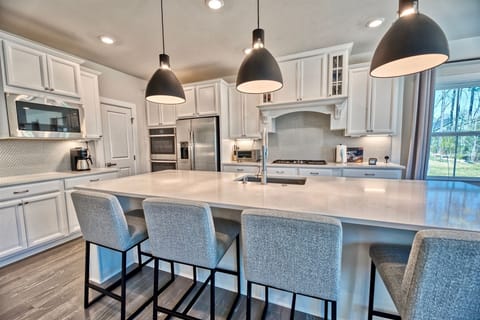 Chef Inspired Kitchen: Quartz countertops, premium cabinetry, and high-end appliances make meal prep a breeze.