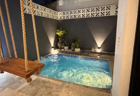 Sun-warmed jacuzzi, BBQ & rustic dining area for relaxing stay.