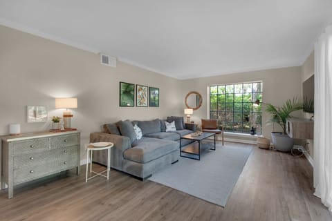 The living room has a comfortable sectional sofa with a seat for everyone.