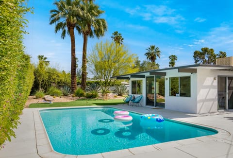 Enjoy a beautiful pool area surrounded by a vibrant desert garden
