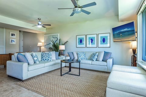 Unwind in your spacious living room with coastal-inspired décor, plush seating, and soothing ocean hues that invite relaxation after a day of adventure.
