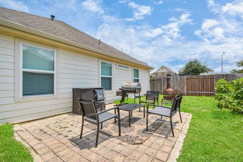 Back yard and patio with grill and seating for 4
