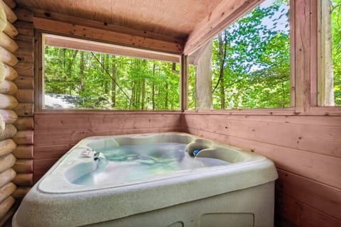 Unwind in the private hot tub with forest views—pure bliss.