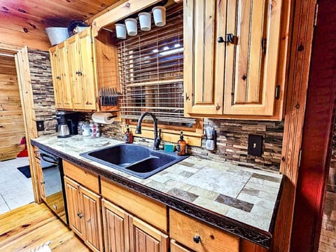 View of the kitchen showing sink, dishwasher and coffee station