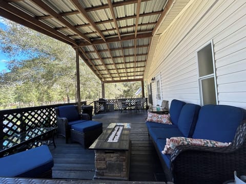 Spacious relaxing covered porch with propane fire table