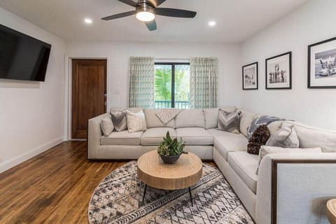 Modern living room with a large sectional sofa and wall-mounted television
