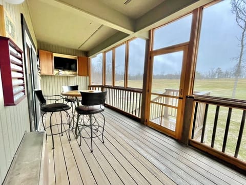 Screened in Balcony overlooking Hole #1 with stairs leading to the golf course.