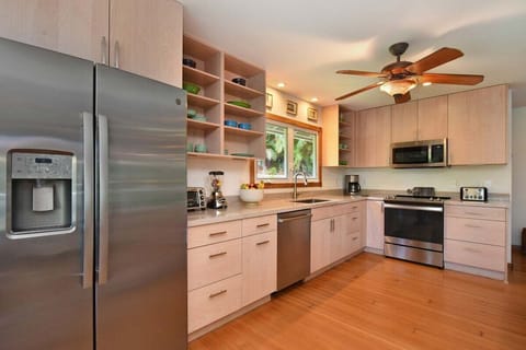Prepare meals in a spacious kitchen with sleek design and island charm.