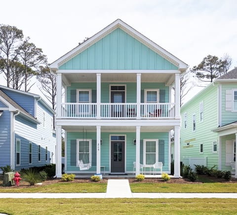 Front of house. Porches off living room and master bedroom.