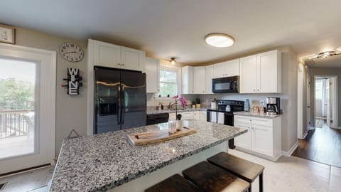 Kitchen with an island that can seat four.