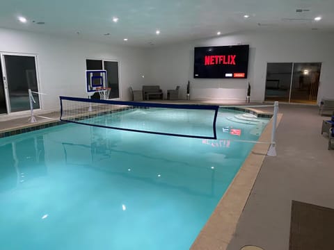 Netflix and swim in a HUGE indoor pool with 4 65” TVs connected as one giant TV 