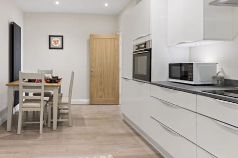 Modern kitchen with all you need for your stay including an oven and microwave and dining area.