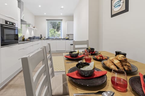 Modern kitchen with all you need for your stay including an oven and microwave and dining area.