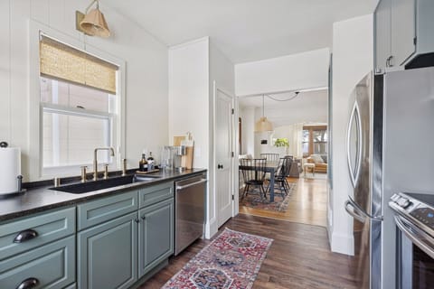 Open concept main living space with full kitchen, dining and living room.