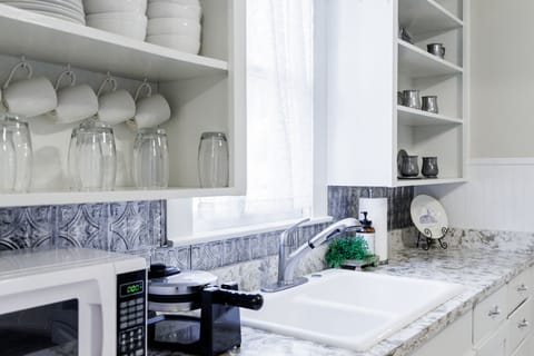 Bright kitchen with marble counters and sink • Modern comfort, classic charm