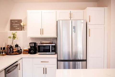 Kitchen with small coffee bar on the counter that includes tea and hot cocoa