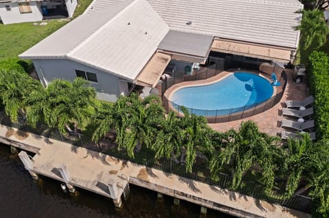Private back yard with lush tropical palms, and water access