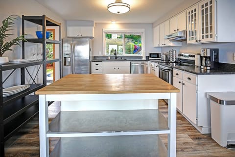 Large butcher block island where everyone can gather to prepare a family dinner.