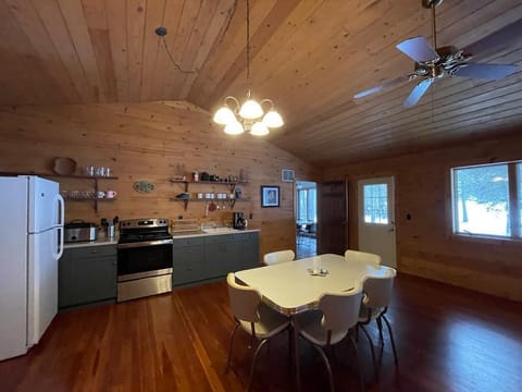 The additional suite includes a kitchenette, dining area, living room, work space, bedroom with Queen bed, and a full bathroom.