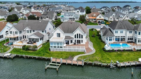 Canal side aerial view of the home showcasing the large deck.  