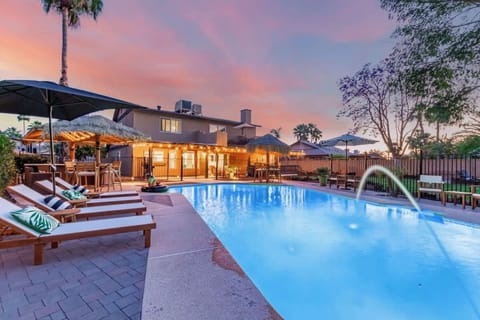 Large pool deck with sparkling blue pool and plenty loungers