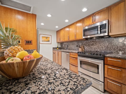 Cook up fresh island meals in this fully equipped granite kitchen with modern stainless steel appliances, perfect for family stays or romantic getaways.