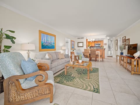 Relax in a breezy open-concept living room with tropical décor, ideal for lounging after exploring Ka'anapali Beach or nearby Lahaina Town.