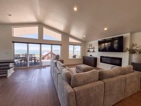 Relax in the bright, open living area with lake views and seamless deck access.