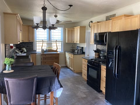Another view of the kitchen and kitchen table. The patio is directly left.